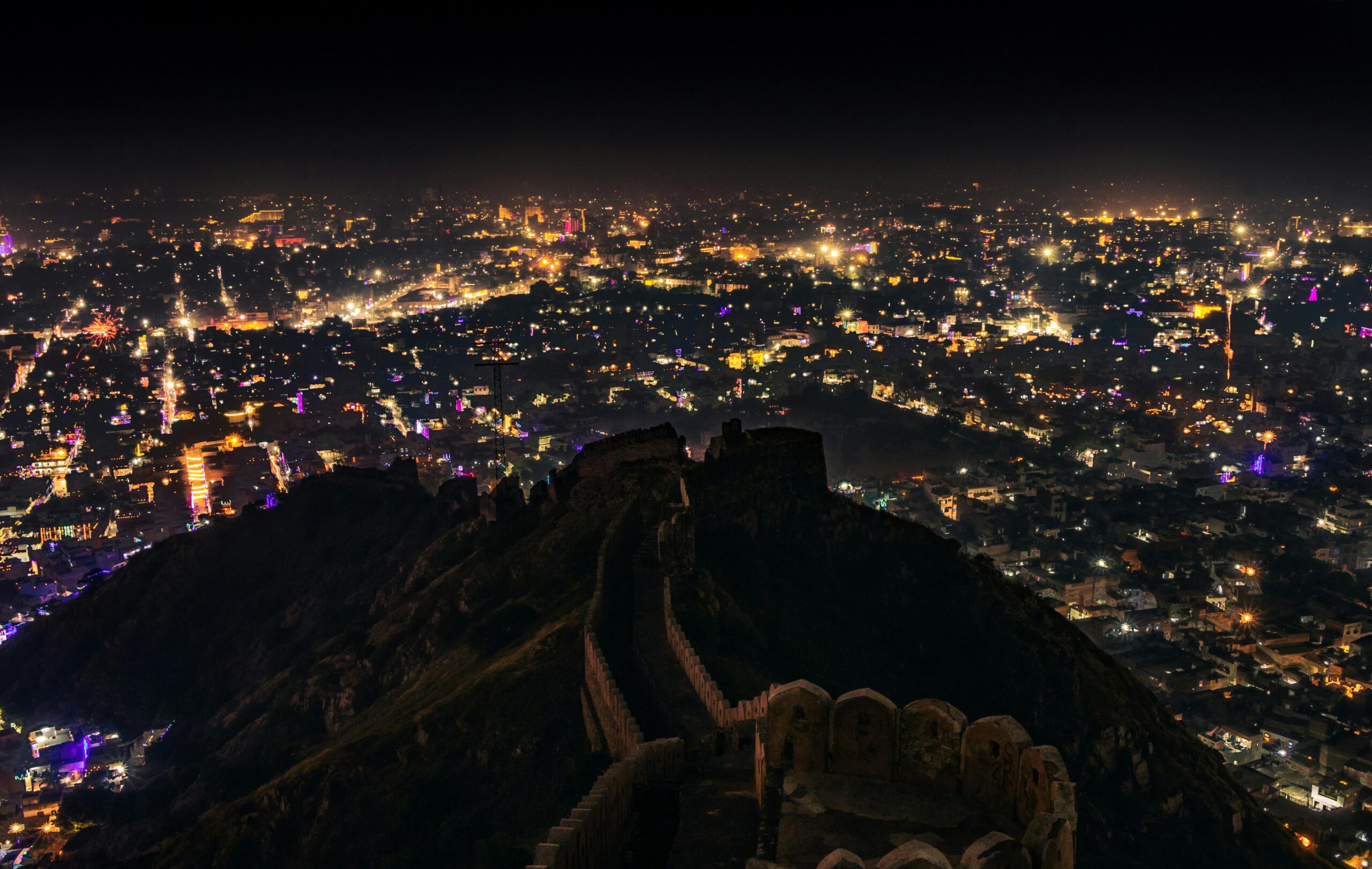 Captivating cityscape of Jaipur at night, seen from Nahargarh Fort's hilltop.