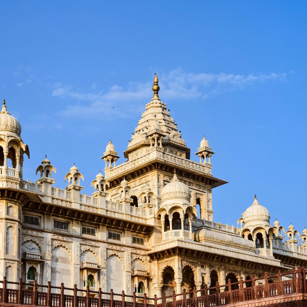 Captivating view of the Jaswant Thada, a stunning marble cenotaph in Jodhpur, India, against a clear blue sky.